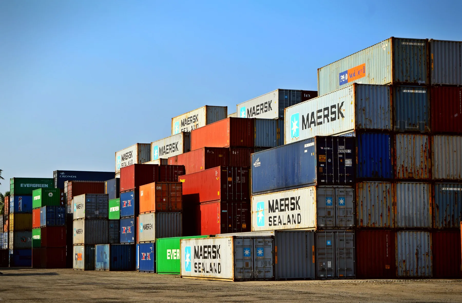 Rows of shipping containers stacked in a cargo yard