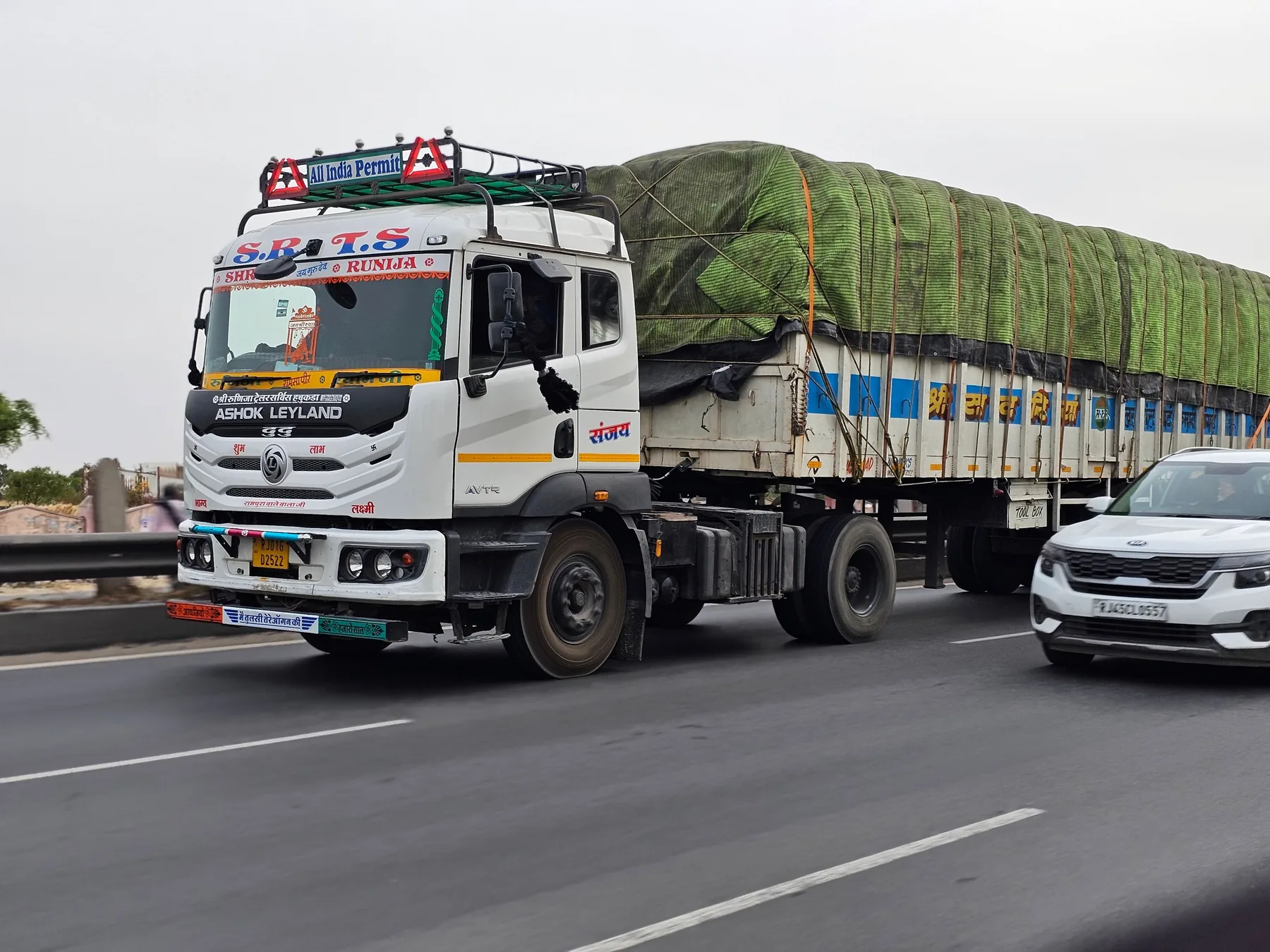 Commercial Indian freight truck carrying covered cargo on a highway