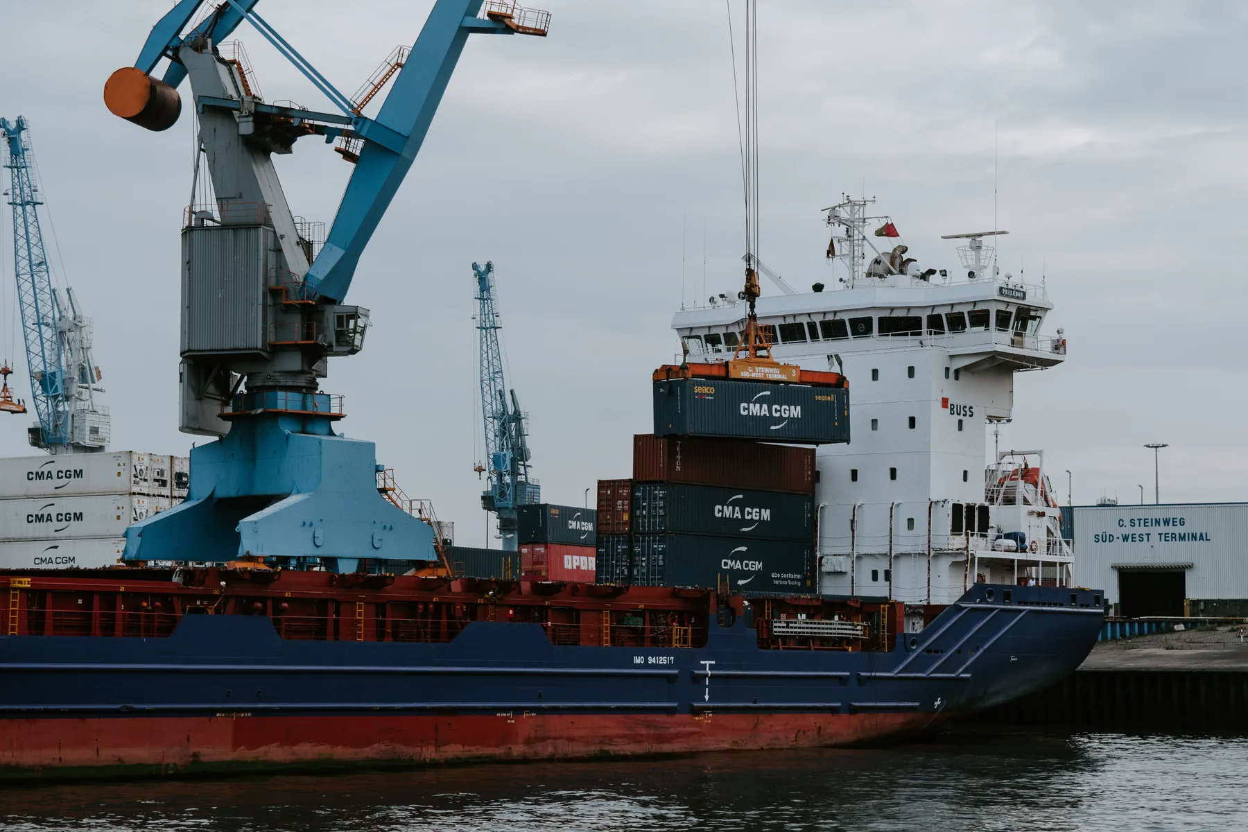 Crane loading a container onto a cargo vessel