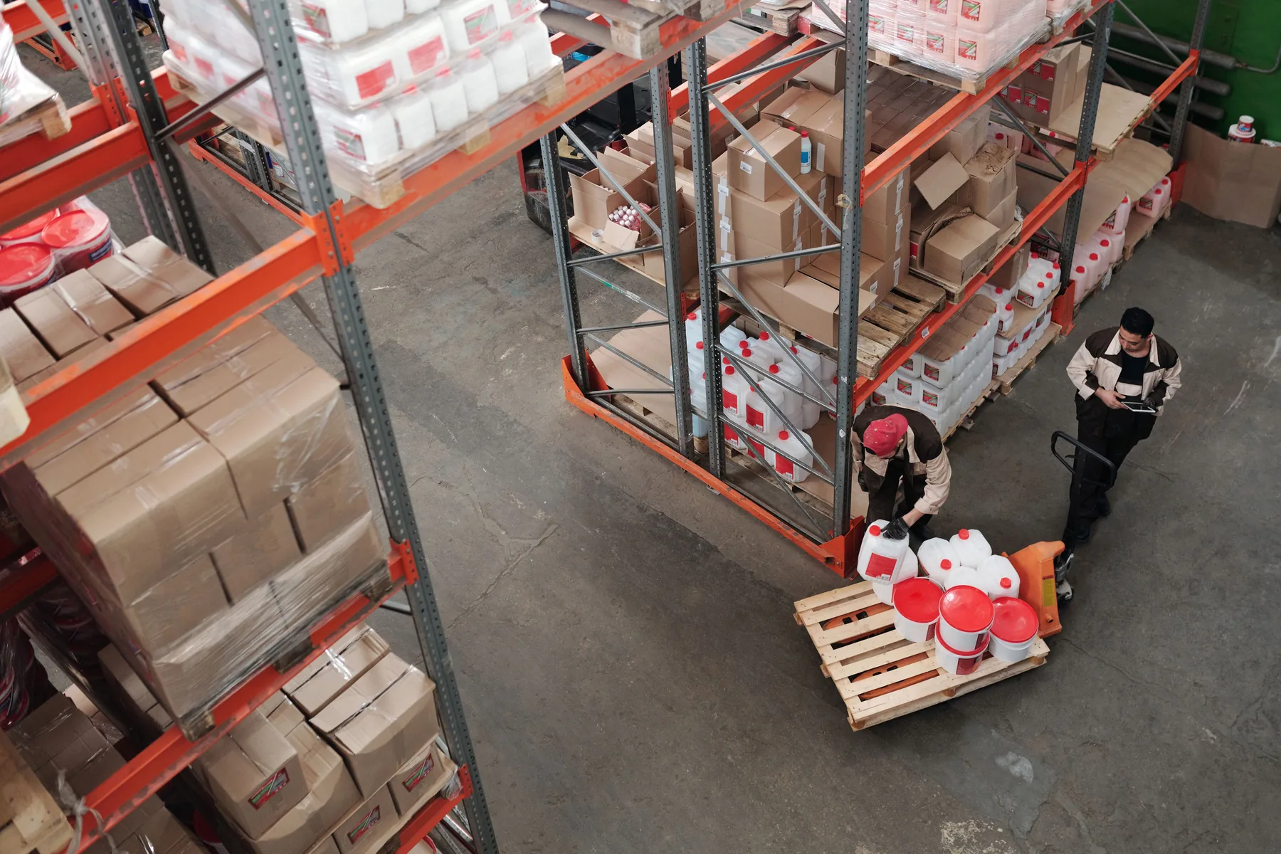 Warehouse team working between high storage racks