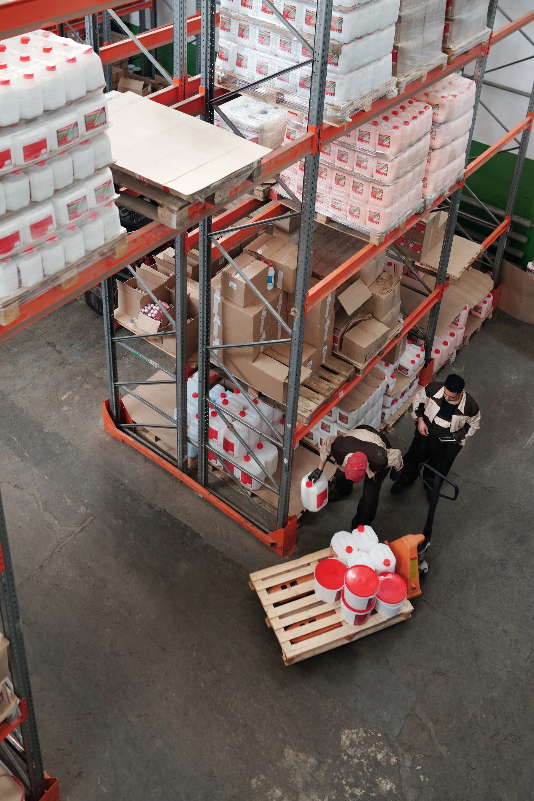 Workers handling inventory inside a commercial warehouse